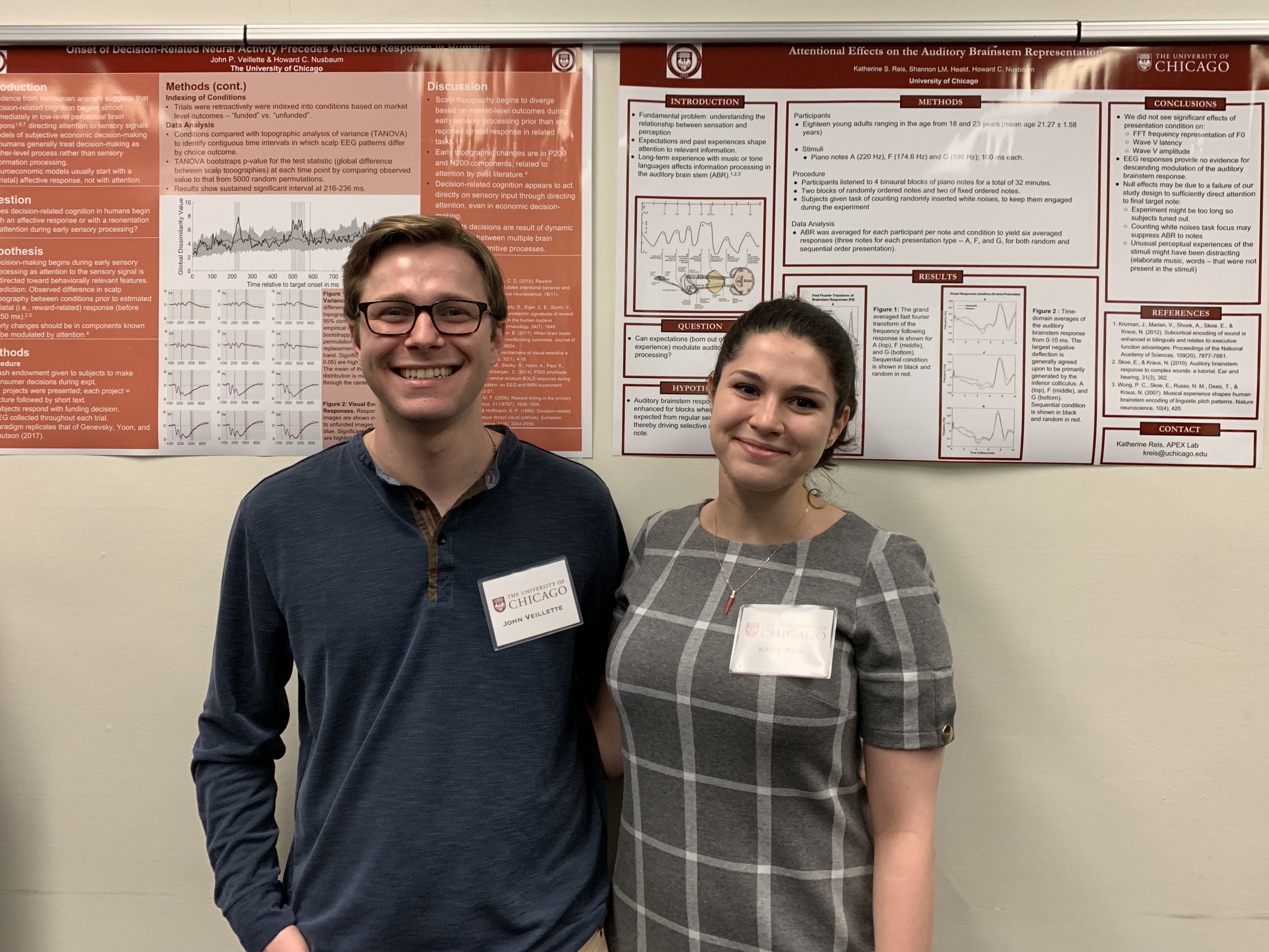 John and Katie are standing in front of their Honors Day posters